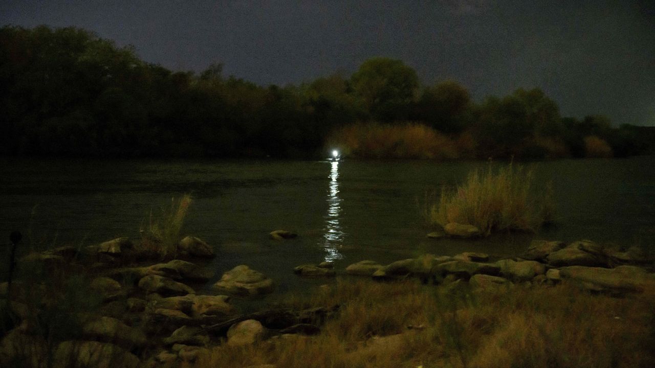 A light shines out from an inflatable boat used to ferry migrants to the United States from the Mexican side of the Rio Grande. 