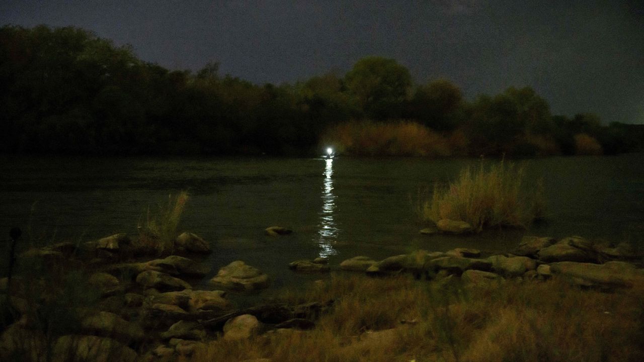 A light shines out from an inflatable boat used to ferry migrants to the United States from the Mexican side of the Rio Grande.