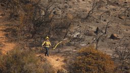 GAVIOTA COAST, CA, CA - OCTOBER 14:                                                              Firefighters from multiple agencies fight the eastern flank of the Alisal Fire along upper Refugio Canyon as it continues to burn Thursday afternoon at near 16,801 acres with 1306 Firefighters on scene. Aircraft will be up making drops throughout the day in support of ground resources putting in line and defending structures. The fire stared Monday afternoon and grew quickly driven by sundowner winds as it burned through Tajiguas Canyon to the 101 freeway forcing closure of the 101 freeway. Mandatory evacuations are in place but winds have subsided Thursday. The 1955 Refugio Fire that consumed 80,000 acres is the last time much of the area had burned. The historic Reagan Rancho del Cielo which sits near the top of Refugio Canyon could be threatened by the flames as the fire moves into Refugio Canyon.  
  Refugio Road on Thursday, Oct. 14, 2021 in Gaviota Coast, CA, CA. (Al Seib / Los Angeles Times via Getty Images).