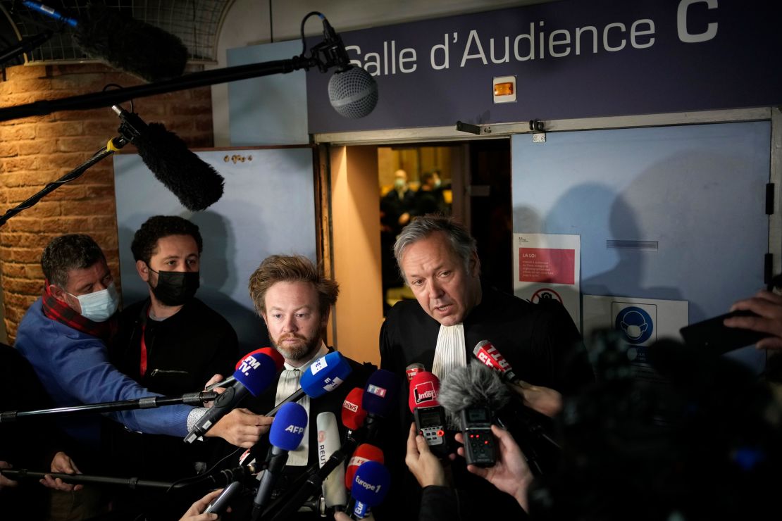Karim Benzema's lawyers Sylvain Cormier, right, and Antoine Vey answer reporters after the verdict in the blackmail court case.