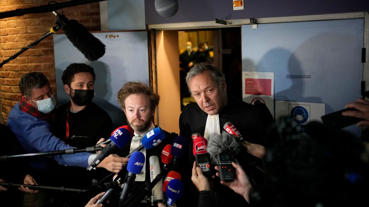Benzema's lawyers Sylvain Cormier, right, and Antoine Vey answer reporters after the verdict.