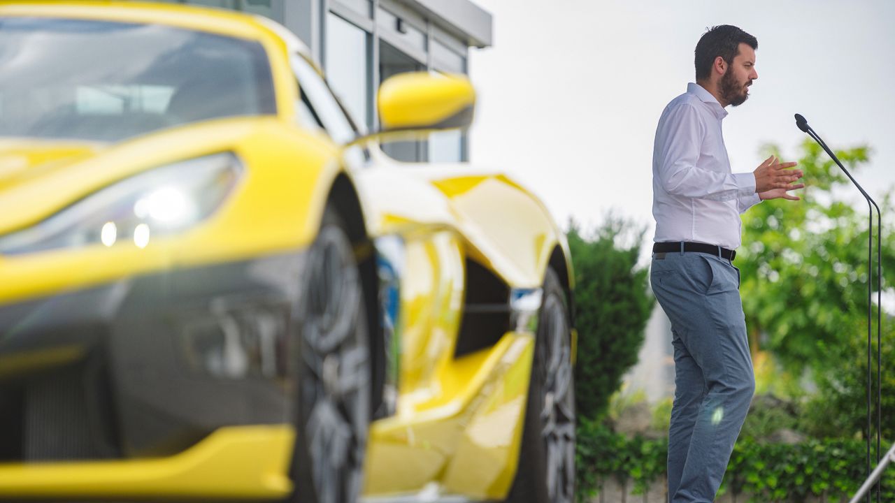 Rimac delivers a speech beside a Rimac Nevera electric supercar outside the company's Croatian factory in in July.