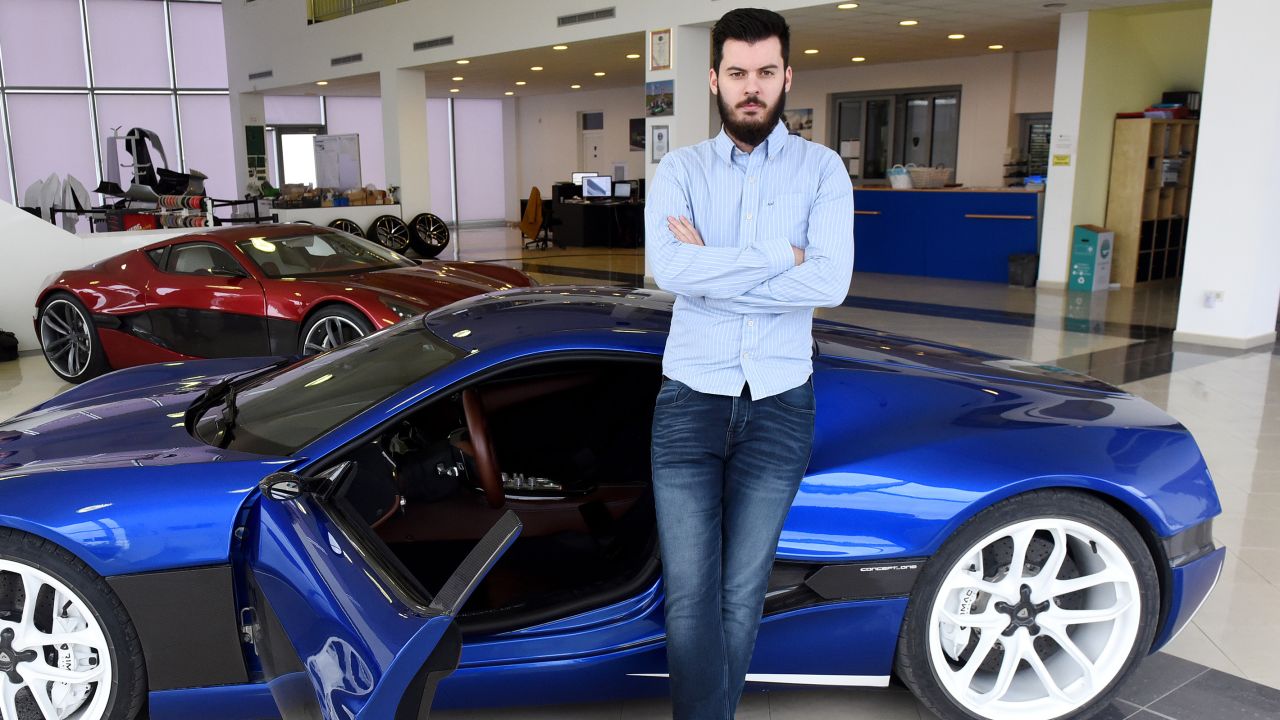 Mate Rimac poses next to his "Concept One" supercar model at his factory and showroom in Sveta Nedelja, Croatia, on February 17, 2016.