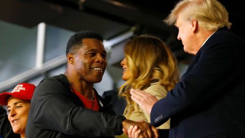 Former football player and political candidate Herschel Walker interacts with former president of the United States Donald Trump prior to Game Four of the World Series between the Houston Astros and the Atlanta Braves Truist Park on October 30, 2021 in Atlanta, Georgia. 