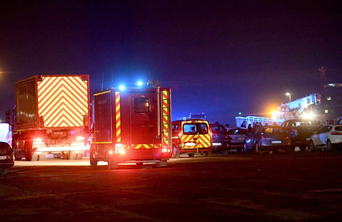 Fire trucks arrive at Calais harbour Wednesday after at least 31 migrants died in the sinking of their boat off the coast of Calais.