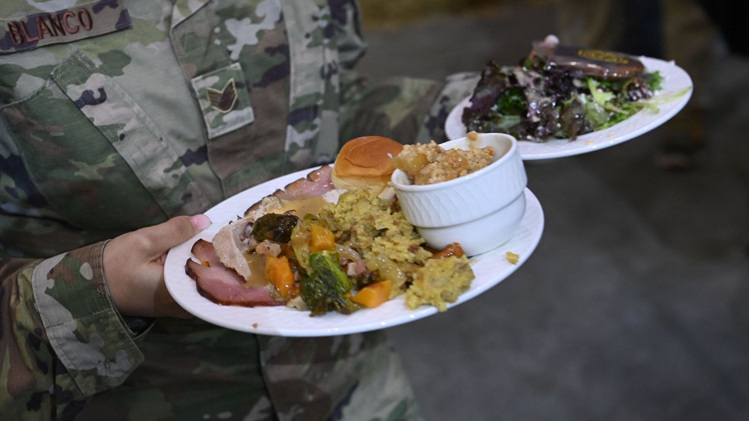 Soldiers hold their plates at Fort Bragg to mark the upcoming Thanksgiving holiday on November 22, 2021, in Fort Bragg, North Carolina. 