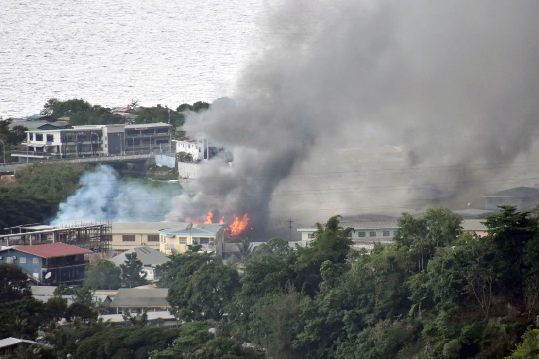 Smoke rises from buildings in Honiara on the Solomon Islands on November 25, on the second day of rioting that left the capital ablaze and threatened to topple the Pacific nation's government. 