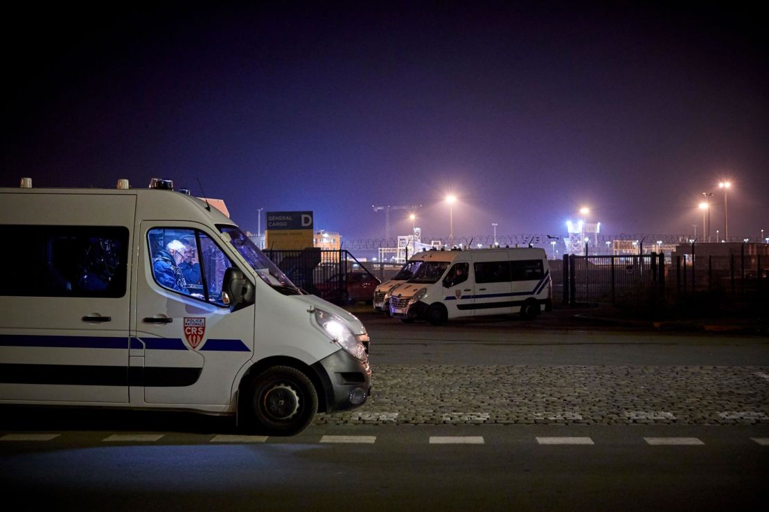 Police seal off the area around the rescue operation at France's Calais harbor on November 24.