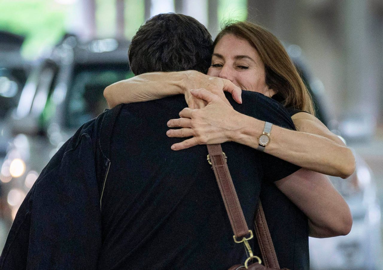 Sonia Covell hugs her son Austin at Palm Beach International Airport in West Palm Beach, Florida, on Tuesday, November 23. He had just arrived from Oakland, California.