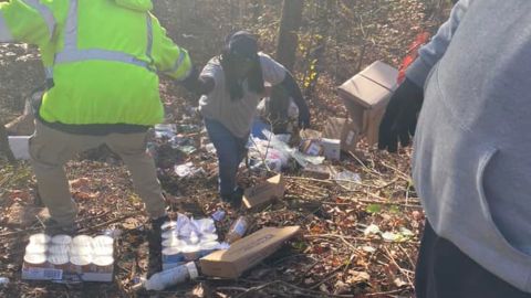 People work to collect packages found in an Alabama ravine last week.
