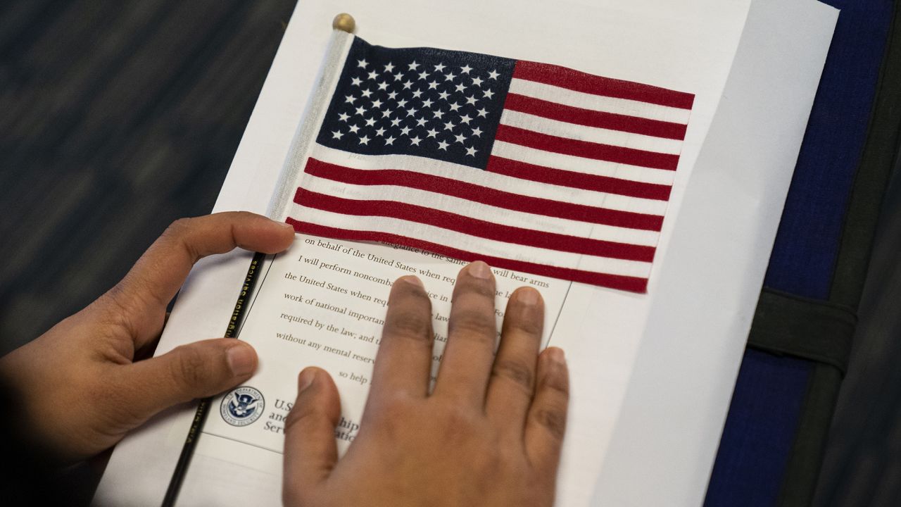 Candidates for US citizenship listen to the presiding field officer during a naturalization ceremony March 8, 2021 in Newark, New Jersey. 