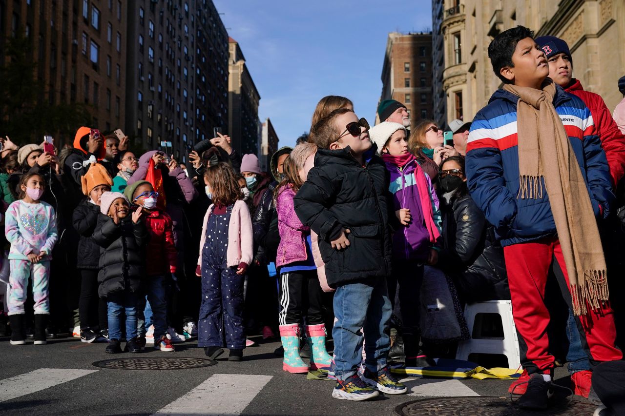 People enjoy the Macy's parade along Central Park West.