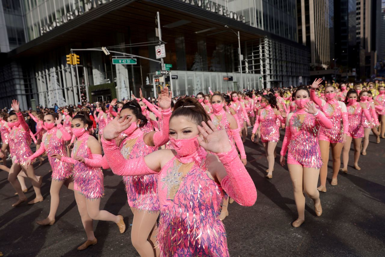 Parade performers cross 42nd Street as they walk down Sixth Avenue in New York.