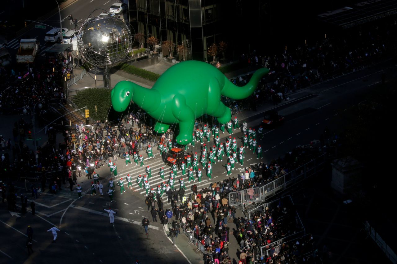 Sinclair's Dino balloon floats over the crowd in New York.