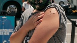NEW YORK, NY - JUNE 05: A 13-year-old newly vaccinateda against COVID-19 shows his bandage at a pop-up vaccination site on June 5, 2021 in the Jackson Heights neighborhood in the Queens borough in New York City. With the Pfizer vaccine approved for children as young as 12 years old, vaccine eligibility has been extended to teenagers and pre-teens in all 50 states. (Photo by Scott Heins/Getty Images)