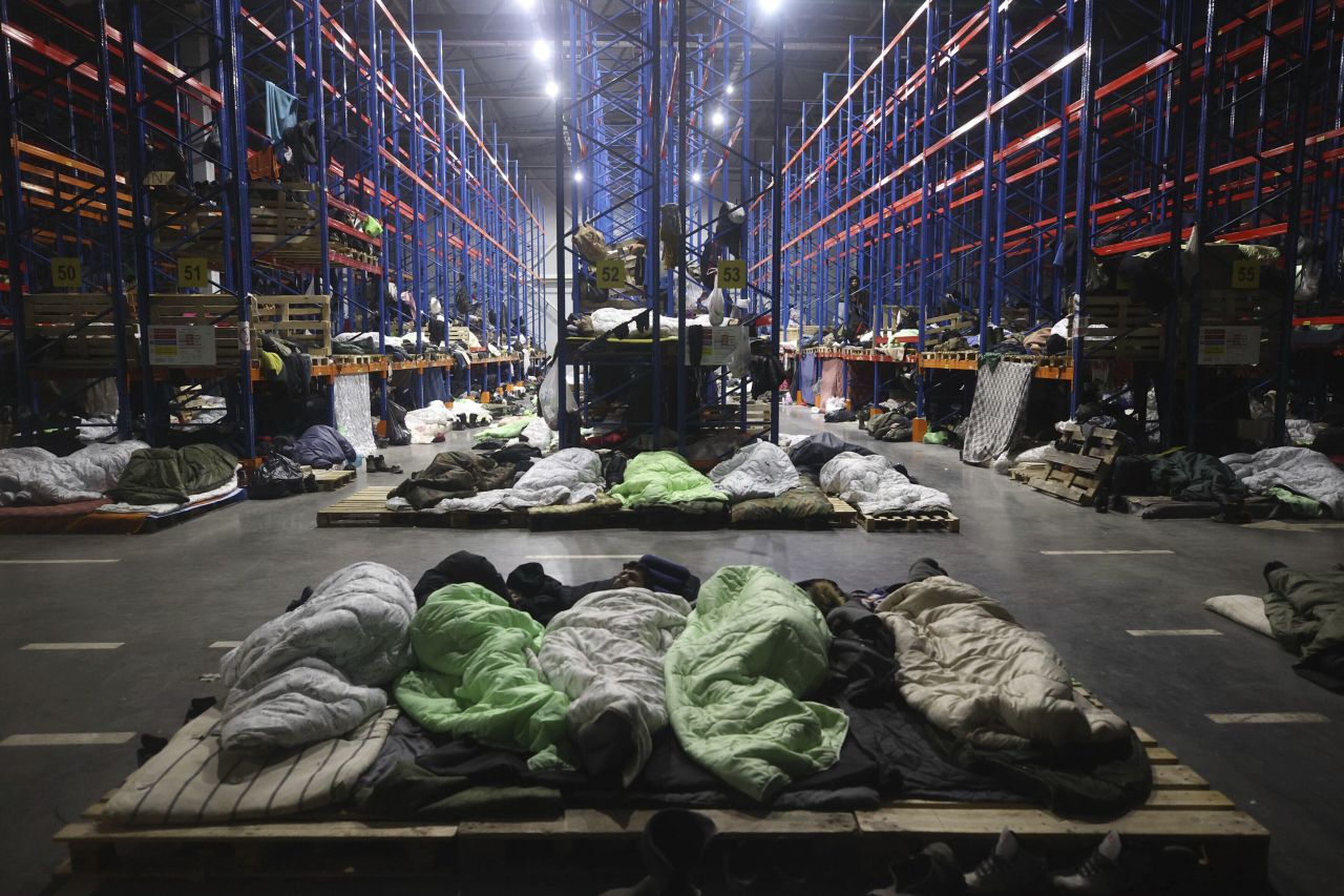 Migrants sleep inside a warehouse in Belarus, near a border crossing with Poland, on Monday, November 22. <a href="http://www.cnn.com/2021/11/11/europe/gallery/poland-belarus-border-crisis/index.html" target="_blank">The migrants,</a> who had been staying in makeshift camps with below-zero temperatures, are at the center of <a href="https://www.cnn.com/2021/11/11/europe/belarus-poland-crisis-explainer-cmd-intl/index.html" target="_blank">a geopolitical dispute.</a>