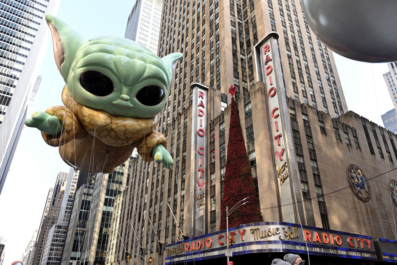 The Grogu balloon passes Radio City Music Hall during the Macy's Thanksgiving Day Parade in New York City.