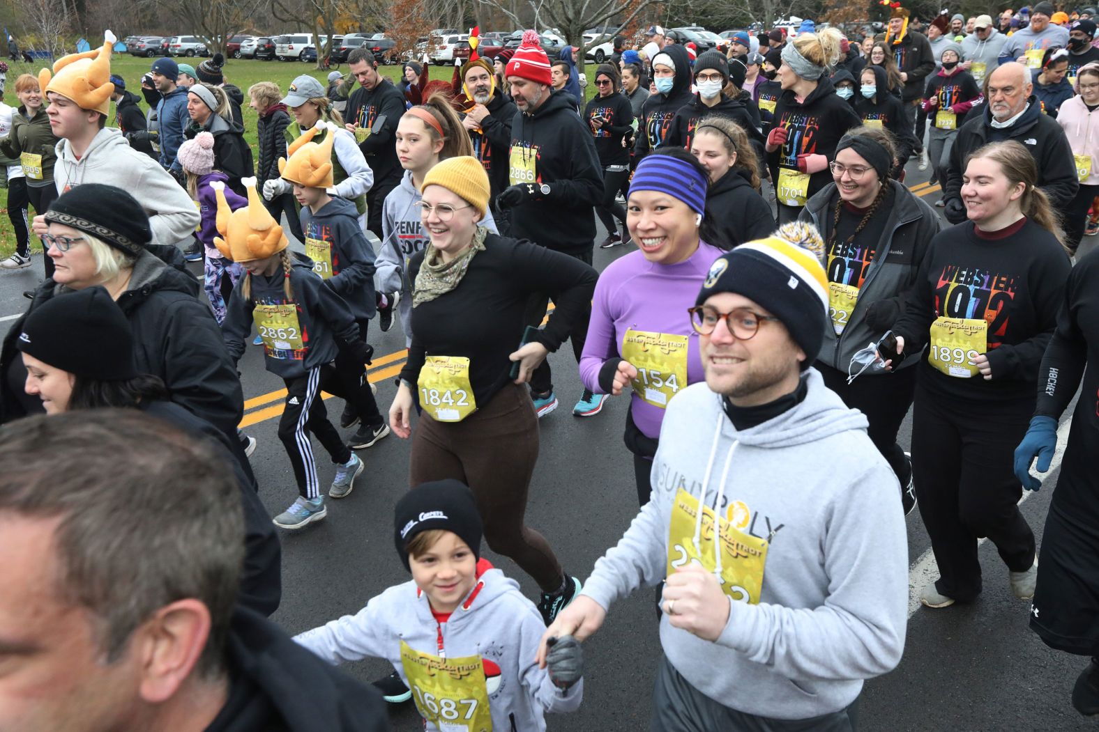 Runners take off at the start of a 2.5-mile race as they participate in the 50th annual Webster Turkey Trot in Webster, New York, on Thanksgiving Day.