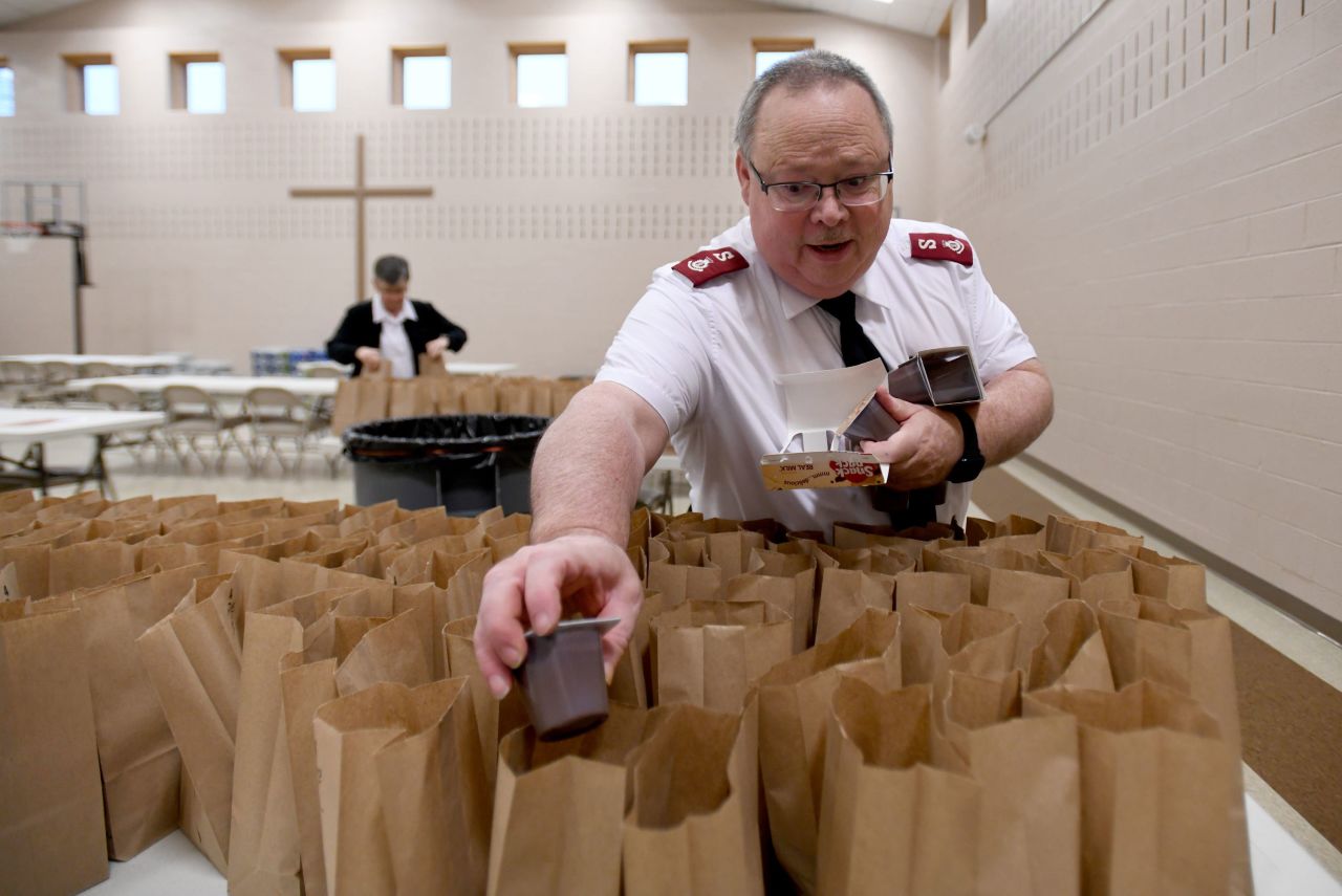 Maj. Tom Perks fills treat bags as they prepare for Thanksgiving guests at the Massillon Salvation Army in Massillon, Ohio.