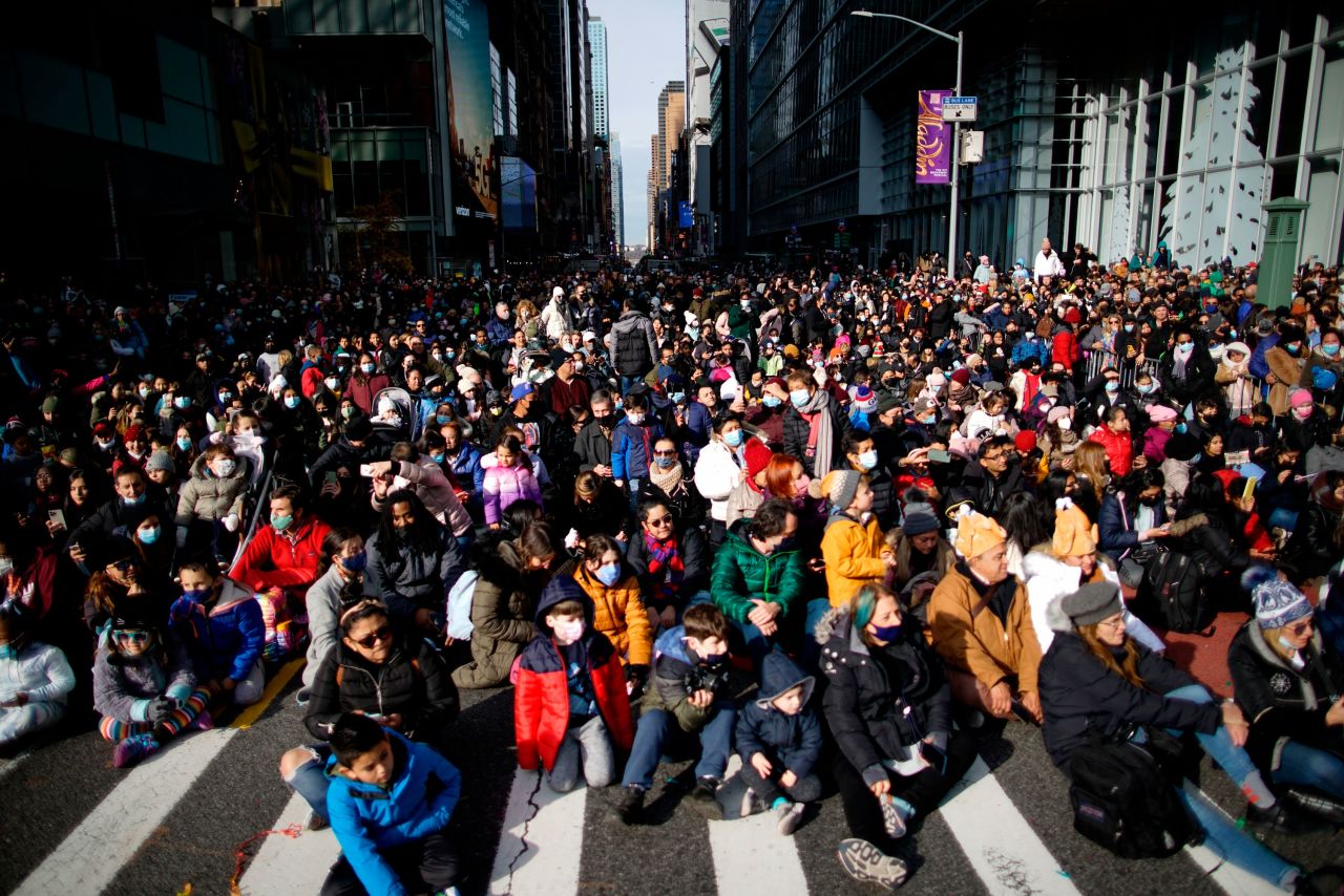 Spectators sit on the street during the Macy's parade in New York.