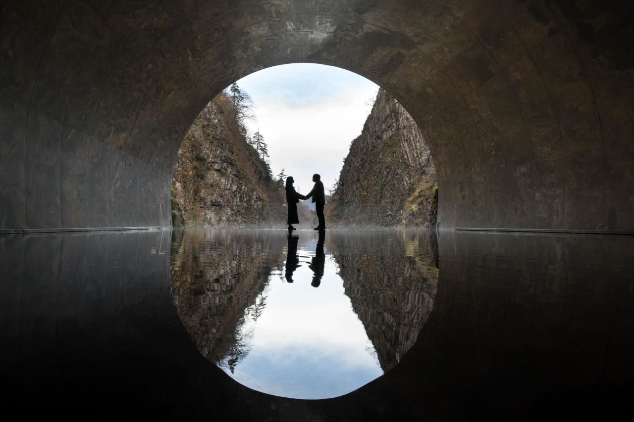 Visitors pose for a photo in the middle of the artwork "Tunnel of Light" at the Kiyotsukyo Gorge in Tokamachi, Japan, on Sunday, November 21. The Kiyotsukyo Tunnel was redesigned by artist Ma Yansong of MAD Architects.