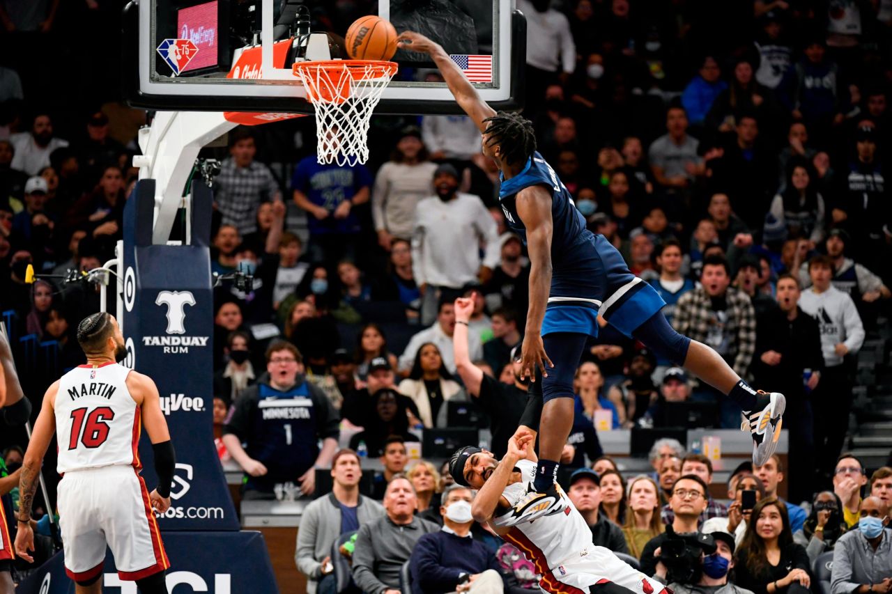 Minnesota guard Anthony Edwards is called for an offensive foul as he dunks over Miami's Gabe Vincent during an NBA game on Wednesday, November 24.