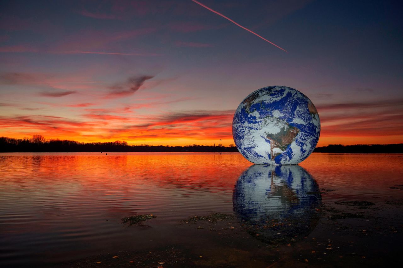 The sun sets behind Luke Jerram's "Floating Earth" installation at Pennington Flash, a lake in Wigan, England, on Monday, November 22.