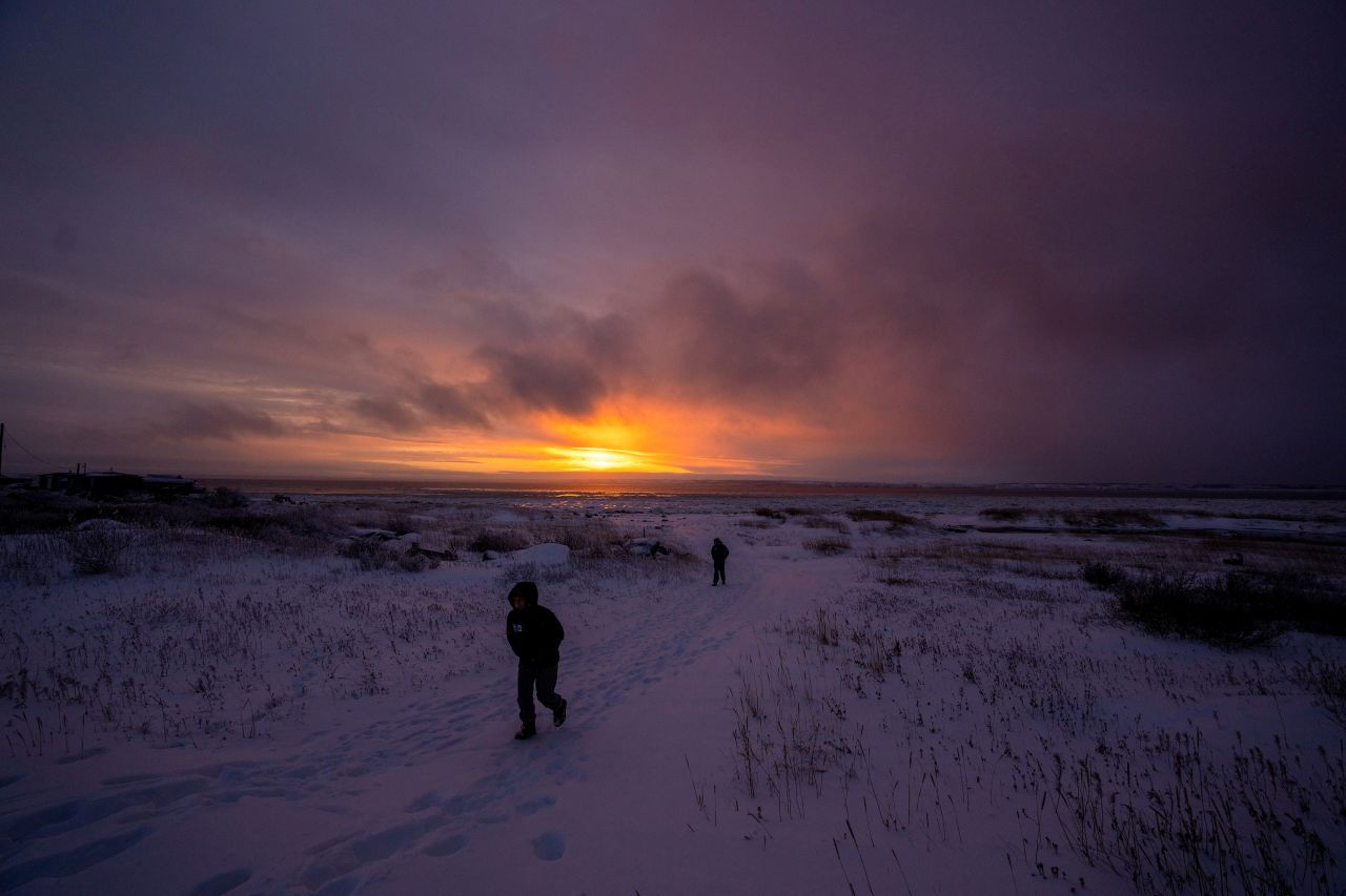 Two people take in a sunset in Churchill, Manitoba, on Friday, November 19.