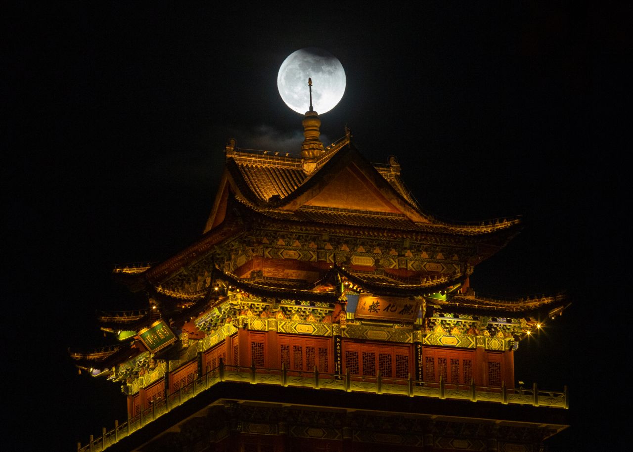 A partial lunar eclipse, <a href="https://www.cnn.com/2021/11/18/world/partial-lunar-eclipse-full-moon-november-scn/index.html" target="_blank">the longest in over 500 years,</a> can be seen above an illuminated building in Jiujiang, China, on Friday, November 19. The eclipse lasted over six hours. <a href="http://www.cnn.com/2021/11/19/world/gallery/photos-this-week-november-11-november-18/index.html" target="_blank">See last week in 40 photos.</a>
