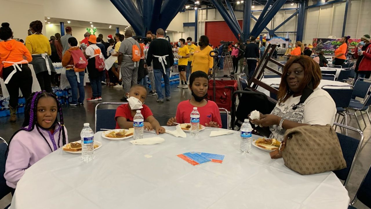 Kimberly Stubblefield, right, gets a Thanksgiving a meal with her three grandchildren as part of the 43rd annual "Super Feast" in Houston.