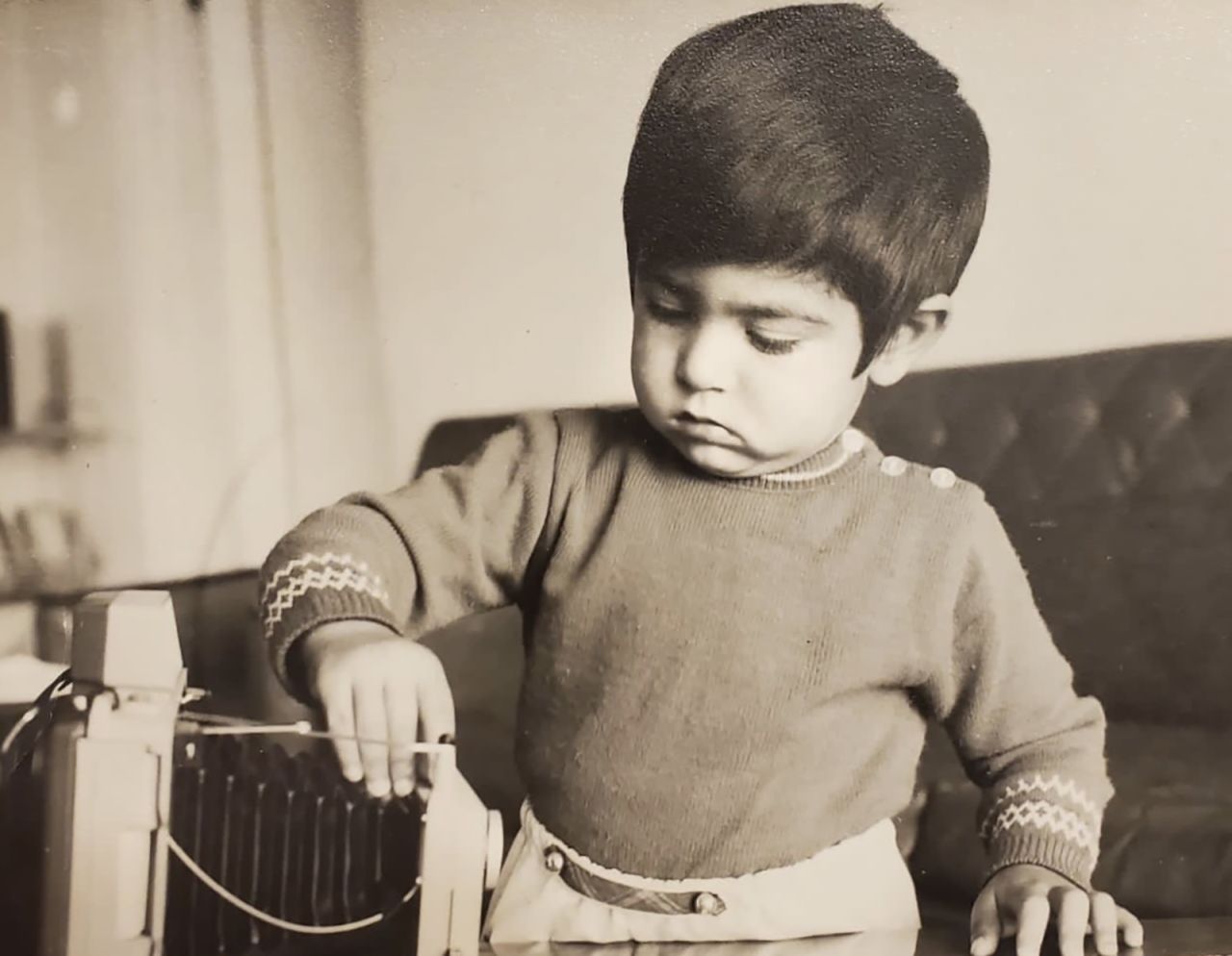 Zak Khogyani playing with a camera as a boy in Afghanistan. He came to the US with his parents when he was 9.