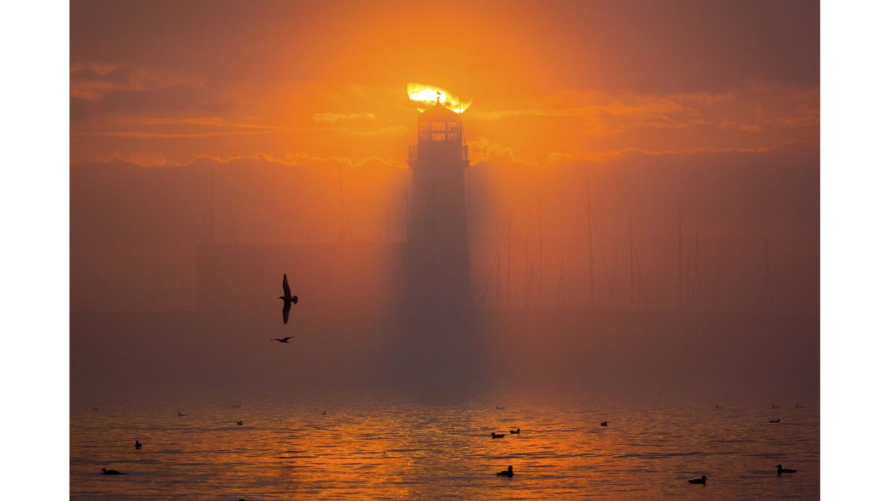 <strong>Scarborough Pier Lighthouse, England:</strong> The lighthouse almost looks like it's on fire in this dramatic sunset snap by Leeds-based photographer Andrew McCaren.
