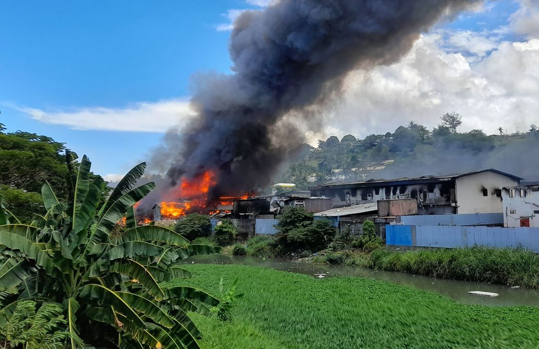 Flames rise from buildings in Honiara's Chinatown on November 26, following days of unrest