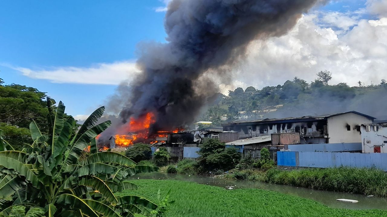 Flames rise from buildings in Honiara's Chinatown on November 26, following days of unrest