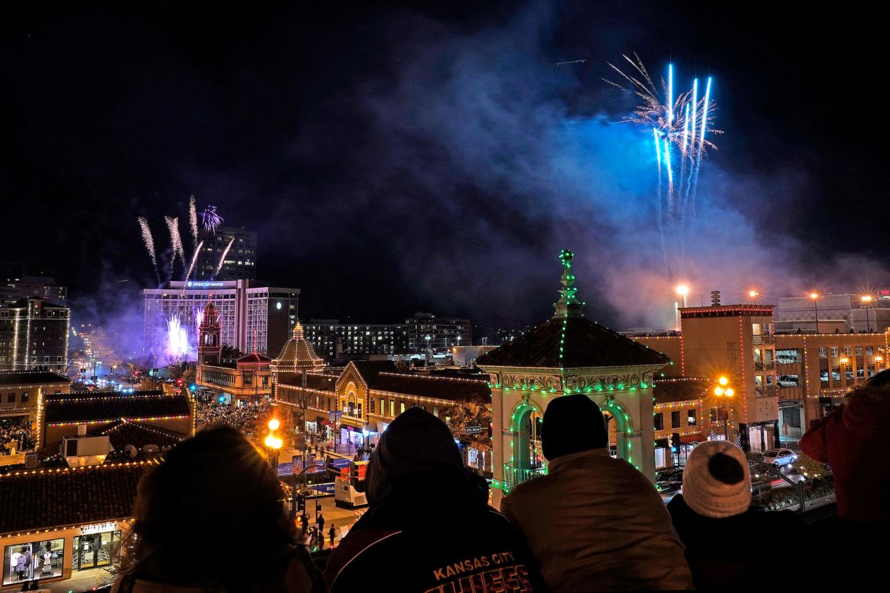 People watch fireworks as the Christmas lights are switched on at the Country Club Plaza shopping district in Kansas City, Missouri.