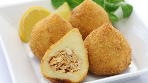Coxinha are fried dough balls with shredded chicken inside.