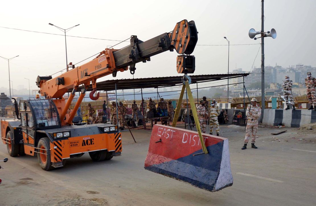 Delhi Police place concrete barriers on the Delhi-Ghazipur border ahead of Friday's farmers protest.