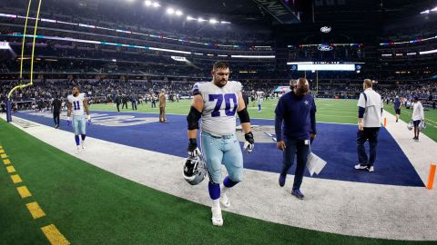 The Dallas Cowboys' Zack Martin and Micah Parsons walk off the field after losing against the Las Vegas Raiders.