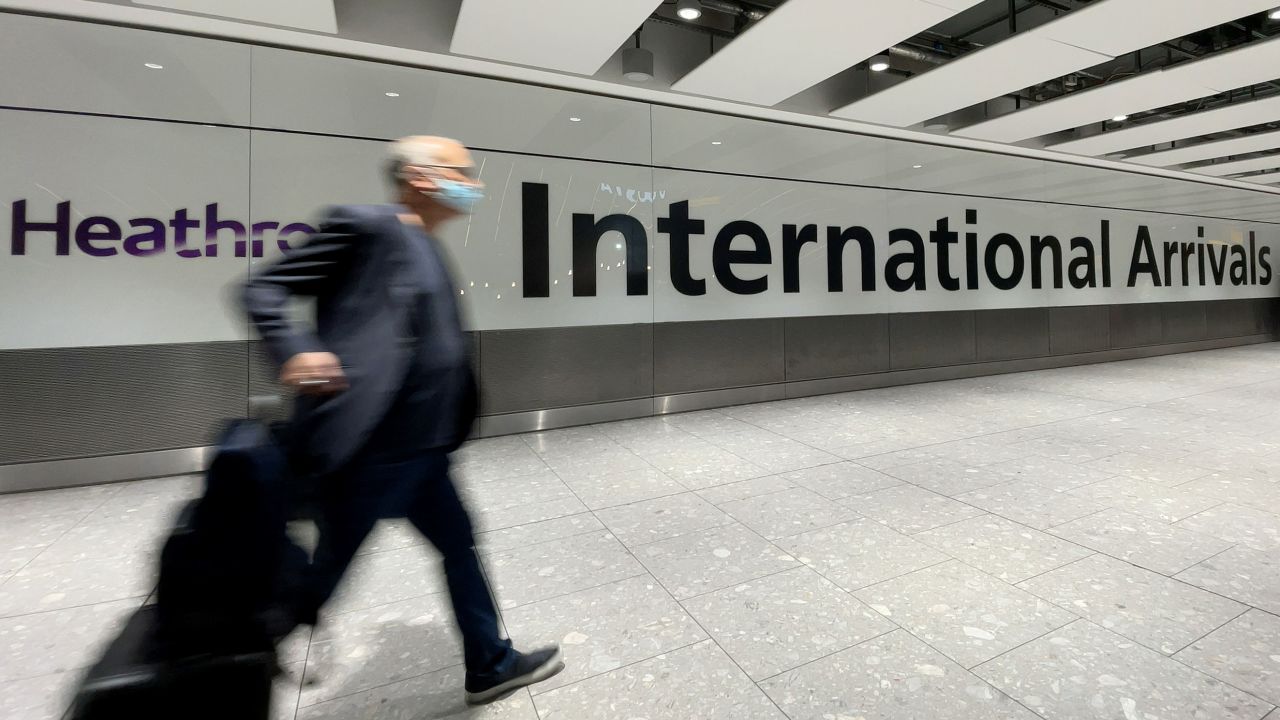 Passengers walk through the arrivals area at London's Heathrow Airport on November 26, after the UK suspended flights from several nations in southern Africa.