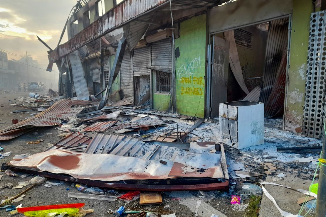 Debris lies on the street outside damaged shops in Chinatown, Honiara, Solomon Islands on November 26.