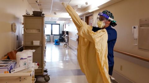 Registered Nurse Monica Quintana dons protective gear before entering a room at the Beaumont Hospital in Royal Oak, Michigan, on April 21.