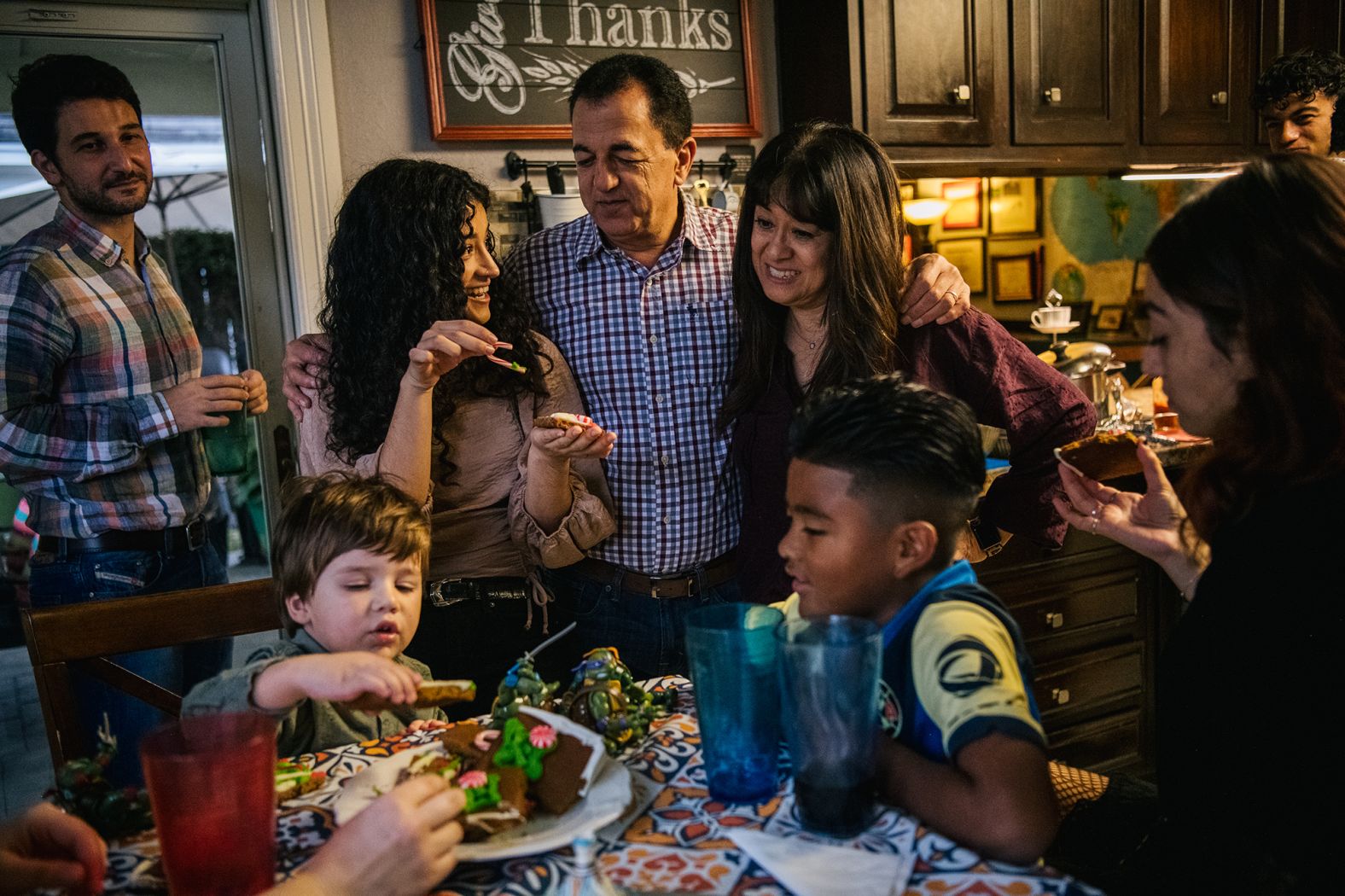 Members of the Villagrana-Ocasio, Parish Moreno and Yagar Dalton families bond together after a Thanksgiving meal in Houston on Thursday. "As happy as I am to have everyone back together, we've experienced so much during the pandemic that in someways it feels that we're almost holding back from truly being able to celebrate," Carlos Villagrana said. "This is our first time having our families come together, and although we're happy and fortunate to be able to share this time, there's this uncertainty in not knowing even what next week will look like. We're happy, but are also very aware of how quickly things can change and are stepping very lightly into the future."