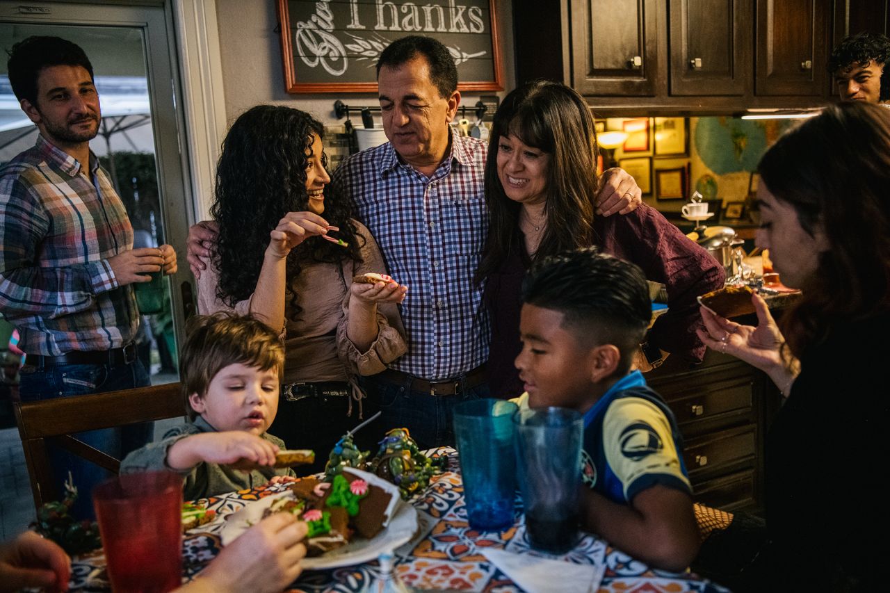 Members of the Villagrana-Ocasio, Parish Moreno and Yagar Dalton families bond together after a Thanksgiving meal in Houston on Thursday. "As happy as I am to have everyone back together, we've experienced so much during the pandemic that in someways it feels that we're almost holding back from truly being able to celebrate," Carlos Villagrana said. "This is our first time having our families come together, and although we're happy and fortunate to be able to share this time, there's this uncertainty in not knowing even what next week will look like. We're happy, but are also very aware of how quickly things can change and are stepping very lightly into the future."