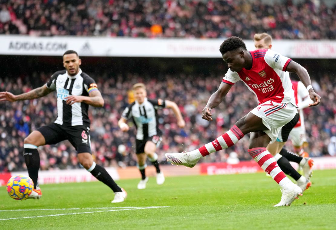 Bukayo Saka, right, scores Arsenal's opening goal in the Premier League match against Newcastle United at the Emirates stadium.