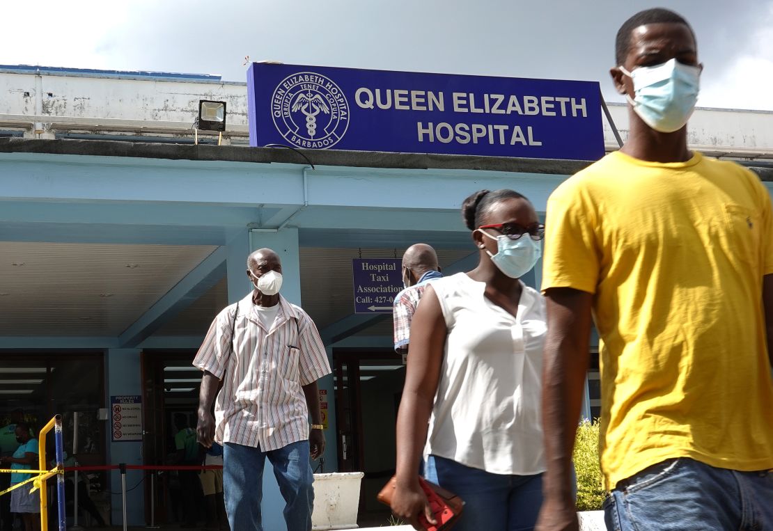People walk from the entrance to the Queen Elizabeth hospital in Bridgetown, Barbados. 