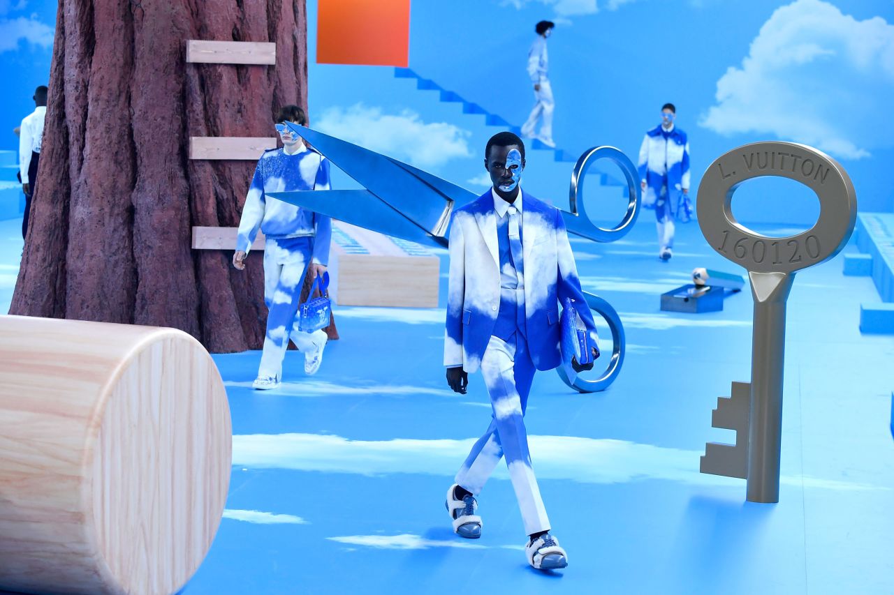Cloud-prints and futuristic face shields made an appearance at Virgil Abloh's Fall-Winter 2020-21 collection for Louis Vuitton, where models walked through a dreamy setting in blue and white outfits.