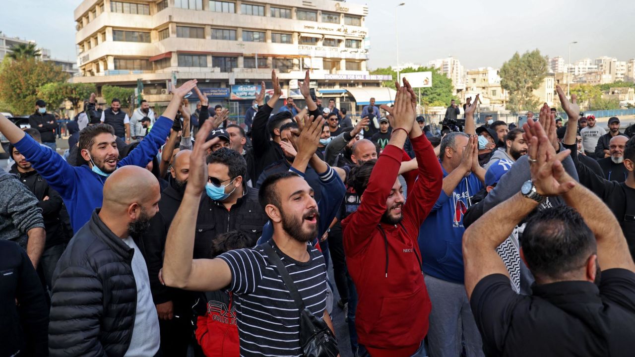 Lebanese protesters clap as they chant slogans during a protest in the capital Beirut on November 29, 2021, as the country struggles with a deep economic crisis. 