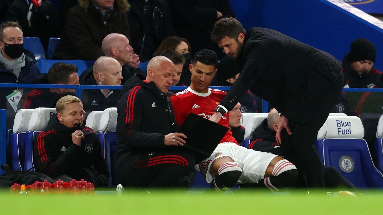 Cristiano Ronaldo of Manchester United takes instructions as he prepares to come on as a substitute during the Premier League match between Chelsea and Manchester United at Stamford Bridge on November 28, 2021 in London.