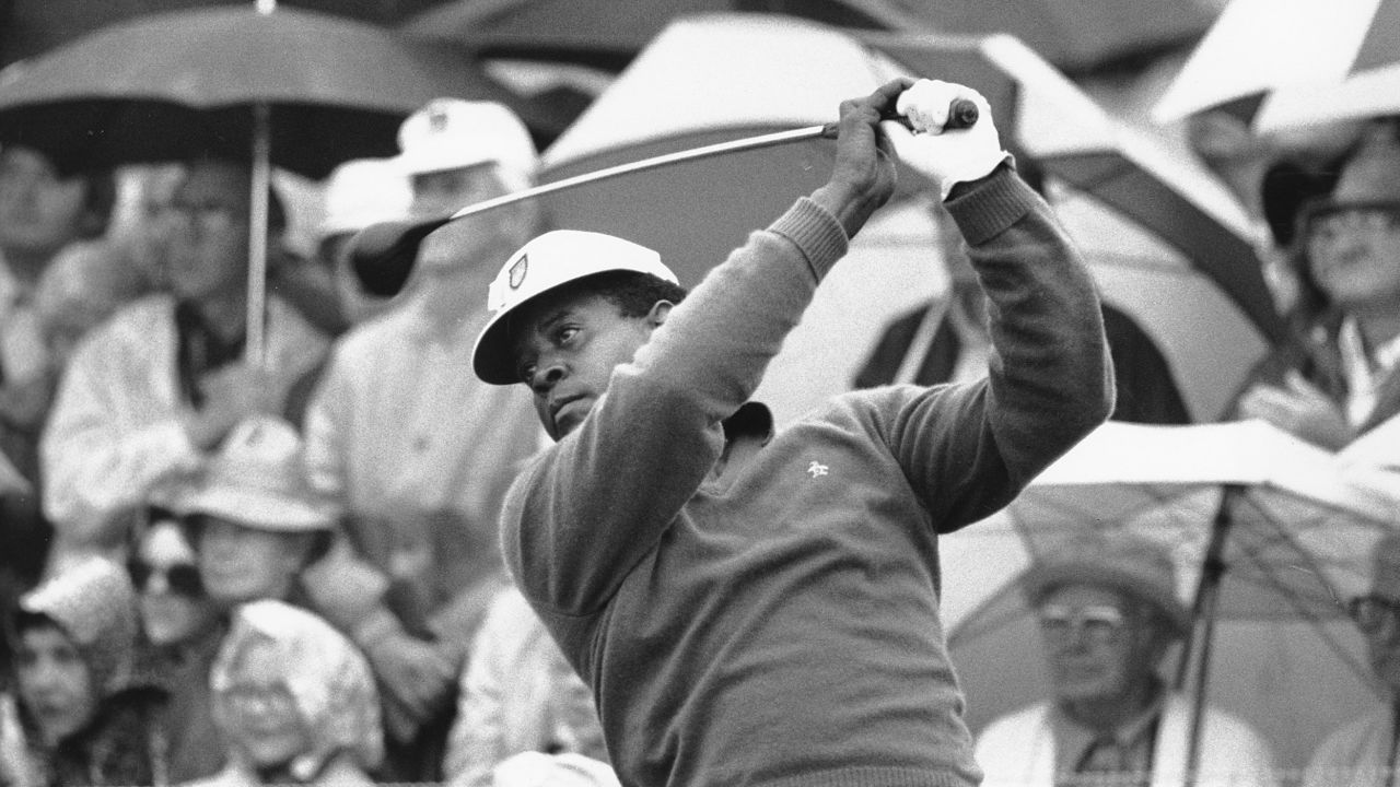 Lee Elder watches the flight of his ball as he tees off in the first round at the Masters in 1975.