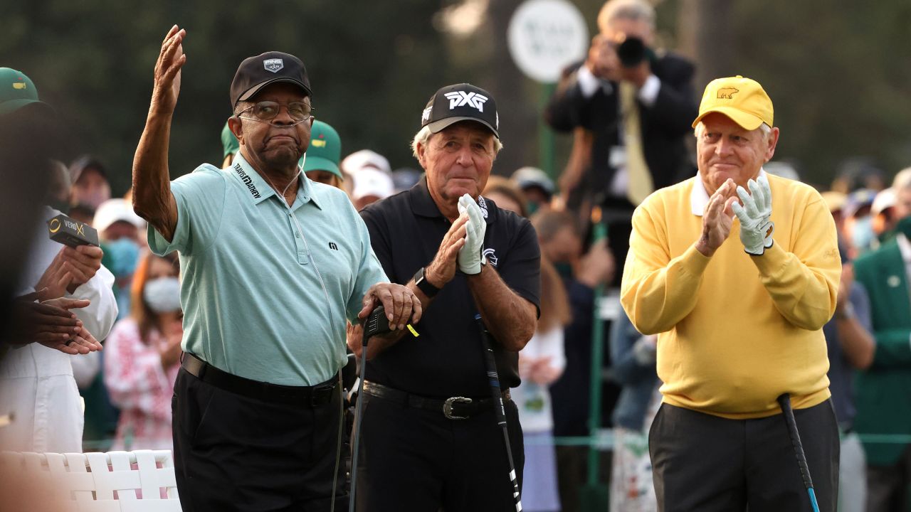 Elder waves to the patrons as he is introduced and honorary starter alongside Gary Player and Jack Nicklaus.